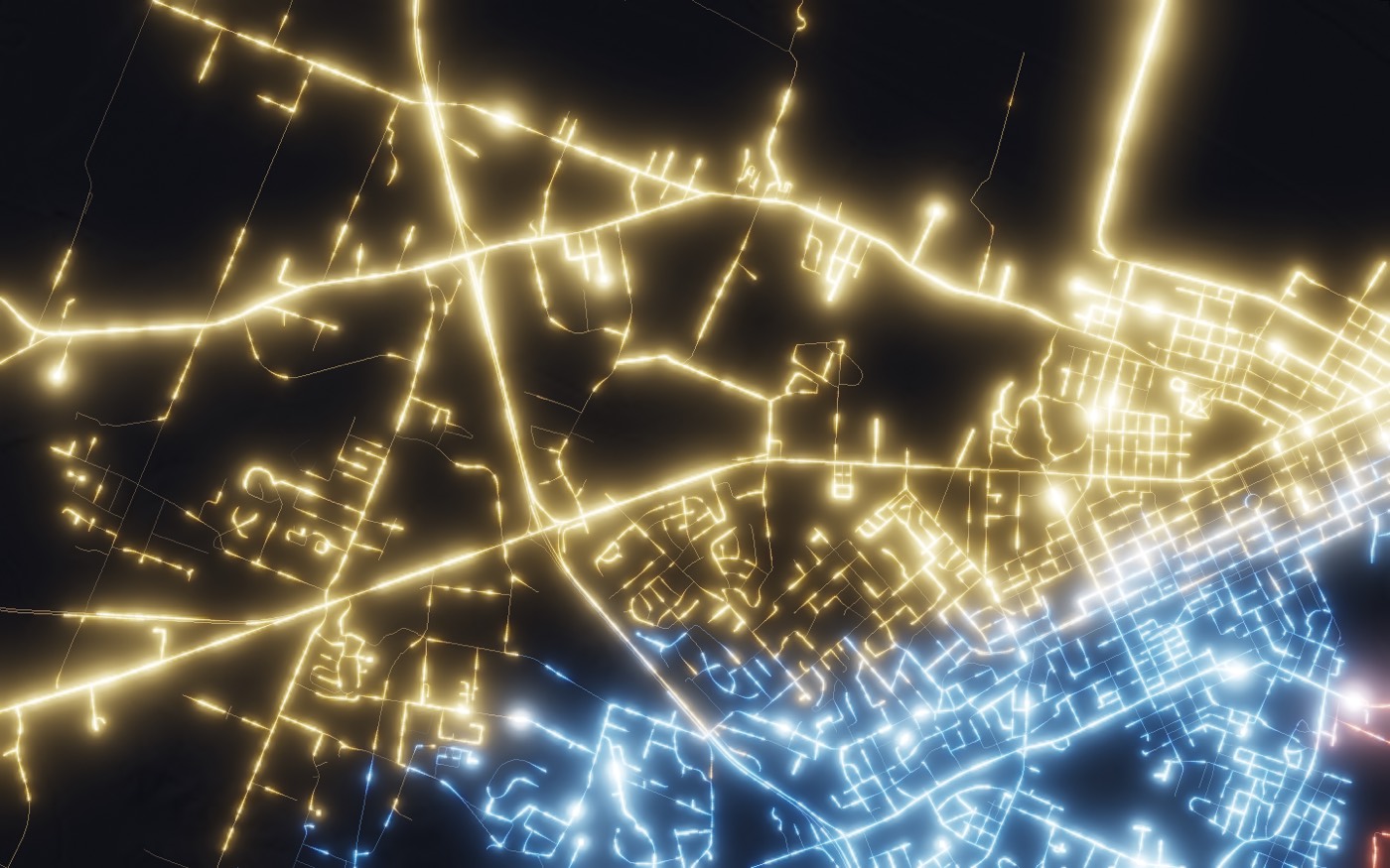 Gold and blue light spreading out from a bright city centre along a web of roads